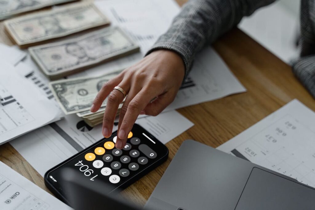 Woman adding up business profits on an iPhone