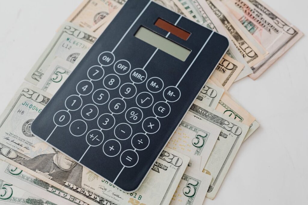 A calculator on a pile of cash