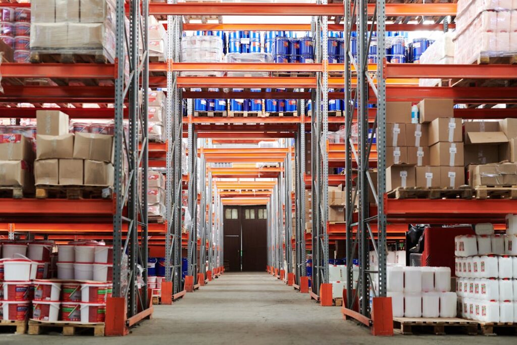 Warehouse full of boxes, barrels, and buckets of inventory