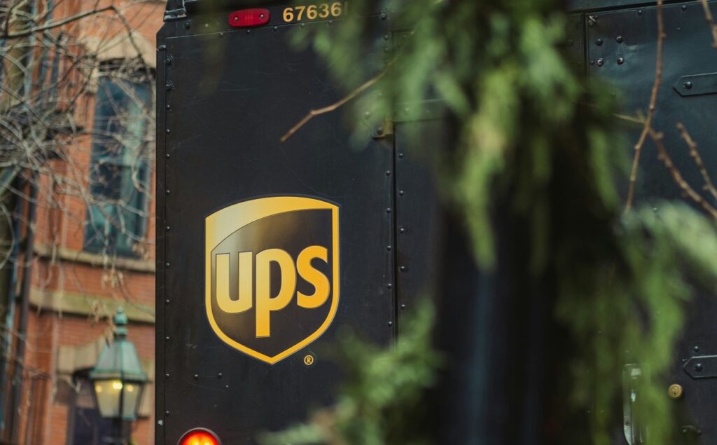 Back of a UPS truck seen through tree branches