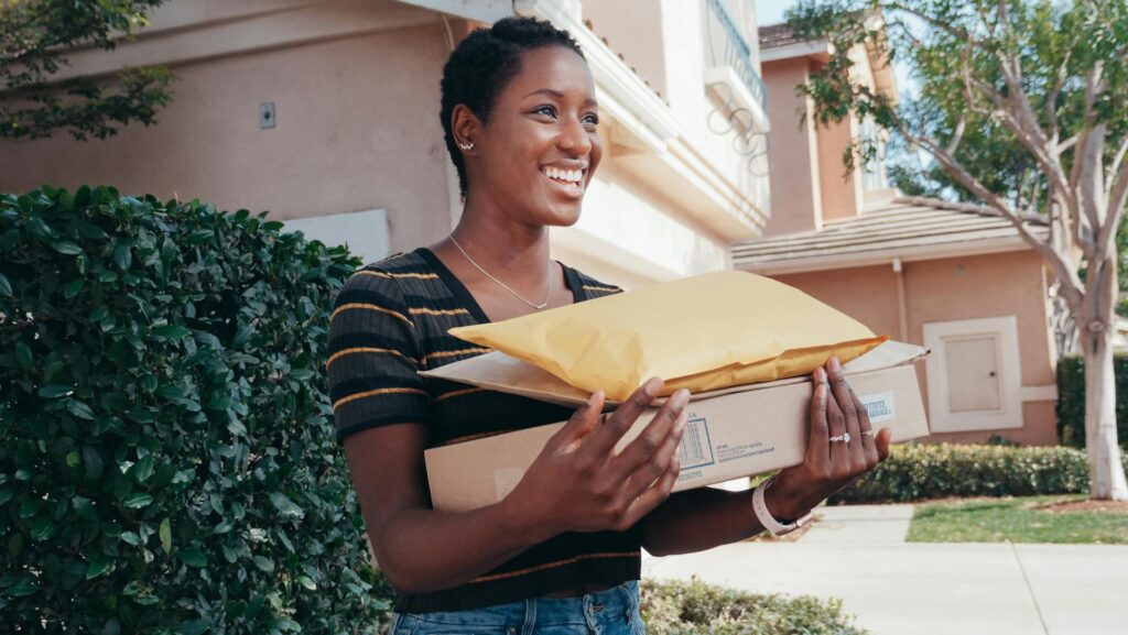 Woman holding several ecommerce packages